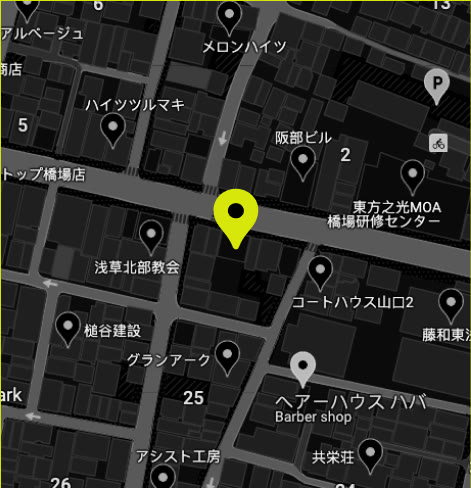 A dark street map of Taito City with the workshop marked in lime.
