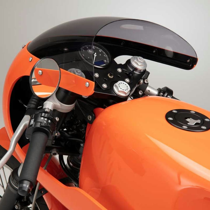 A close view of the CT-10's orange tank, its bar-end mirror and the top yoke.